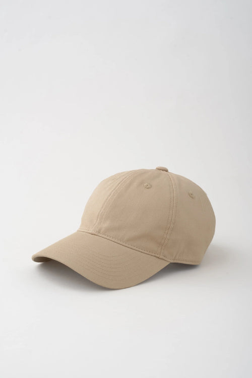 Beige baseball cap on a white background