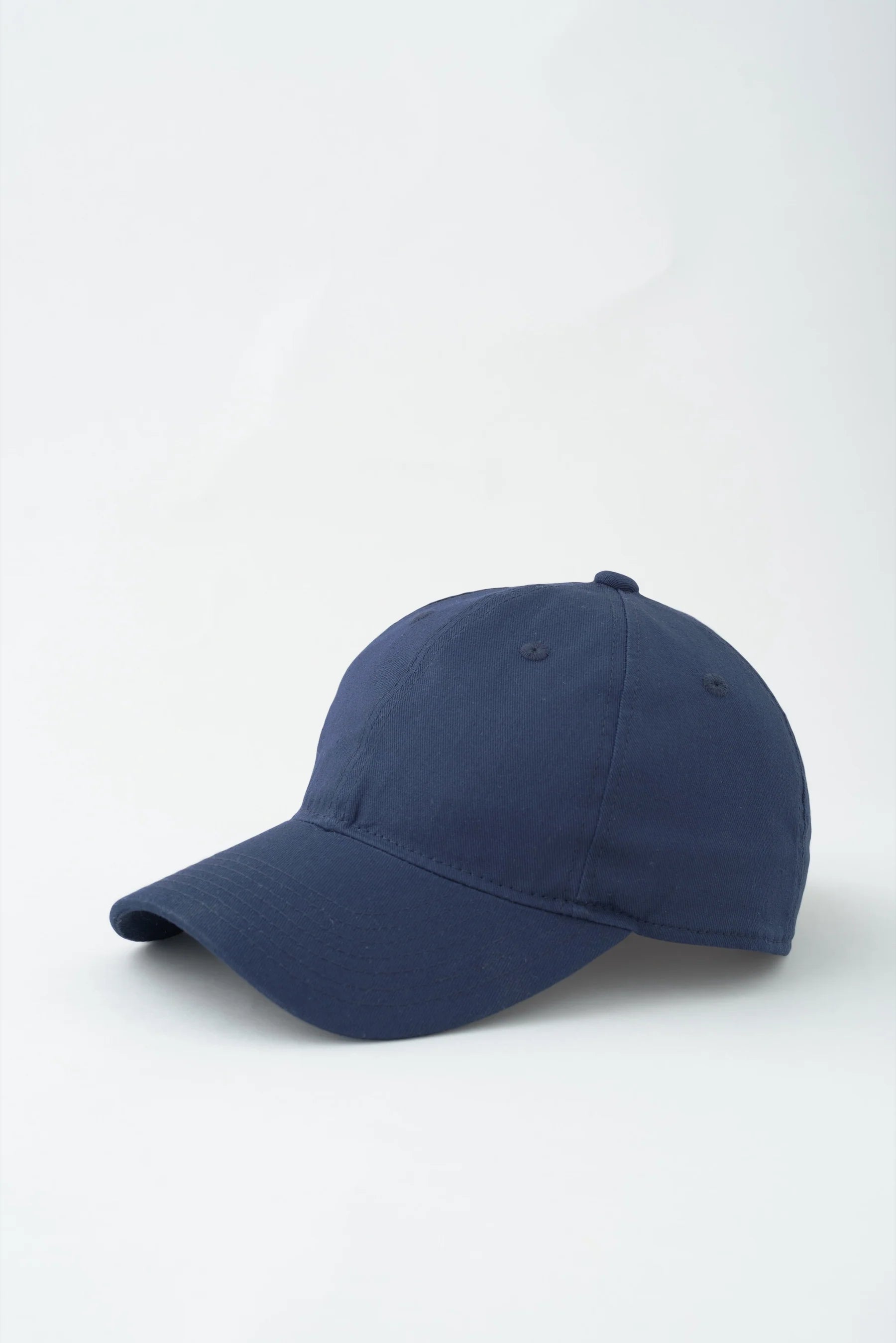 Navy blue baseball cap on a white background